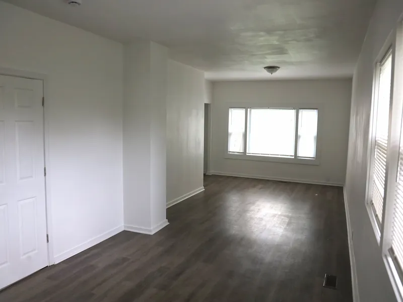 Clean interior room with white walls and vinyl flooring