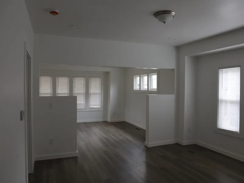 Clean updated interior room with white walls and windows