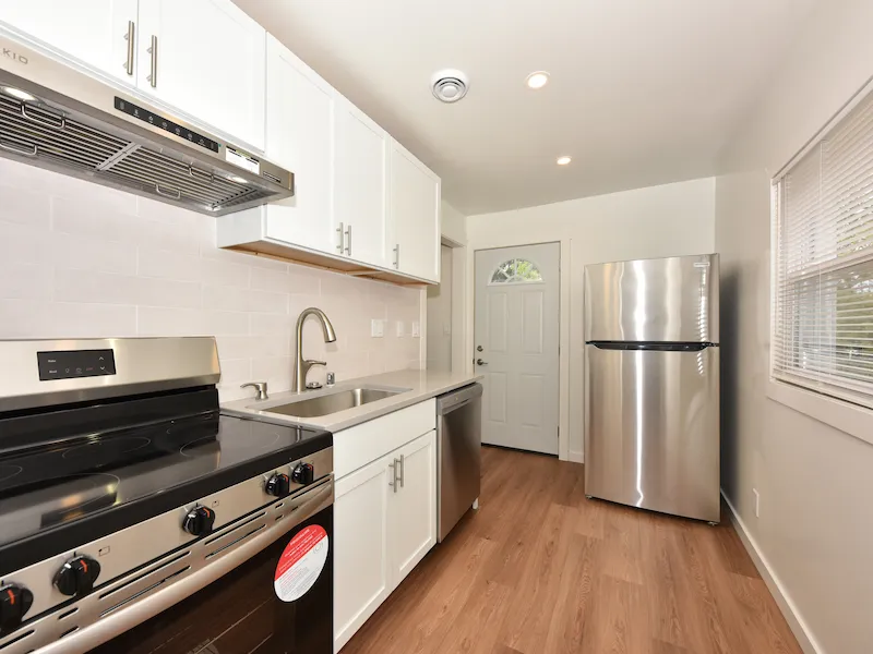 Clean white kitchen with new appliances