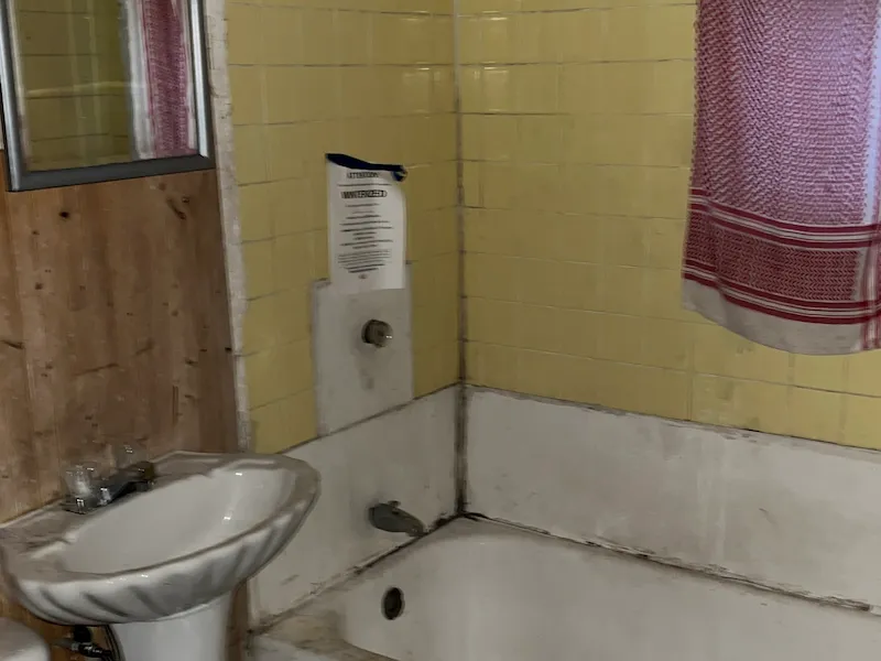 Old bathroom with dirty yellow tile