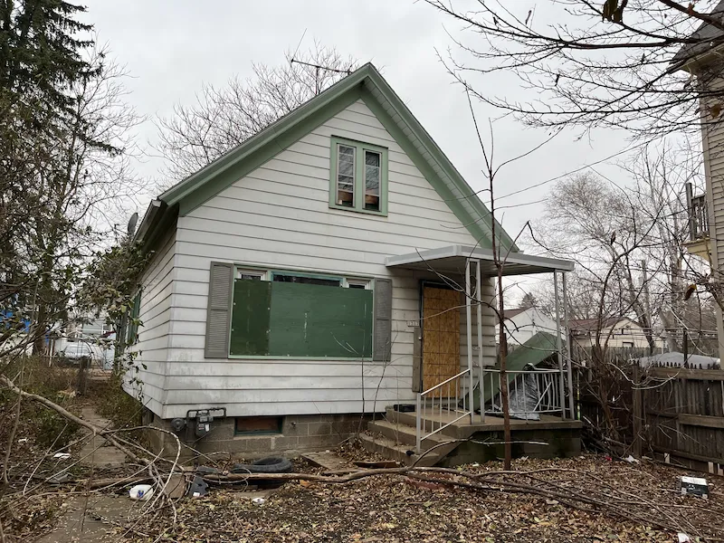 Old white boarded up house
