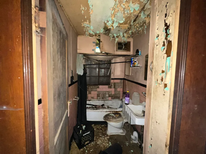 Old bathroom with mold and broken ceiling